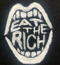 a picture of a patch. the design is of an open mouth, text inside of it reading, "eat the rich"